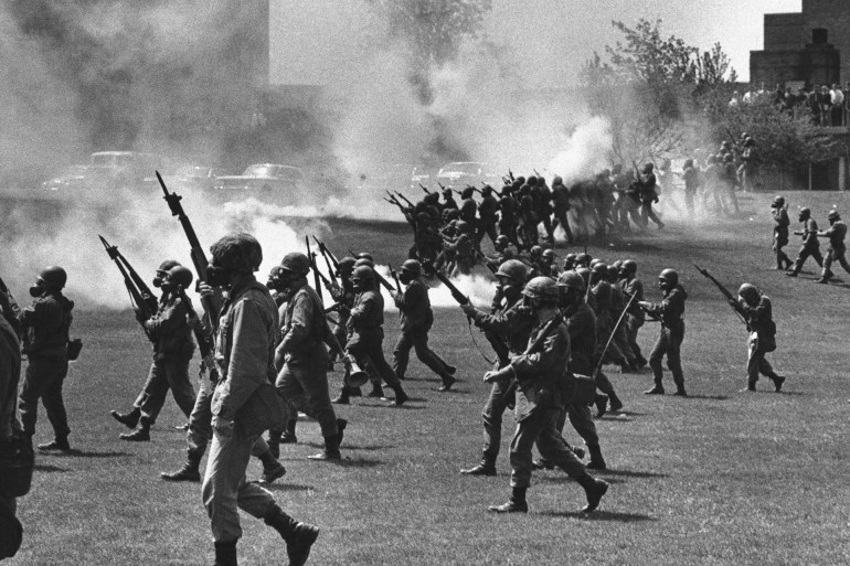 FILE - Ohio National Guard soldiers move in on war protesters at Kent State University in Kent, Ohio, on May 4, 1970. Four people were killed and multiple people were wounded when National Guardsmen opened fire. (AP Photo, File)